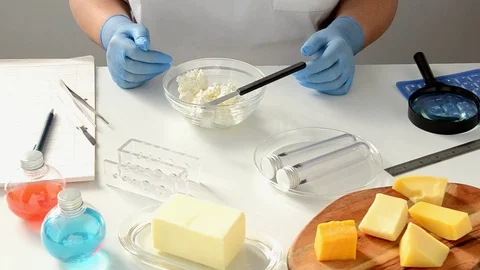 Taking bit of cottage cheese into test-tube Video stock 69882905