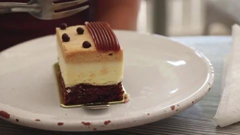 Taking a bite of a caramel cake Stock Footage 238629129