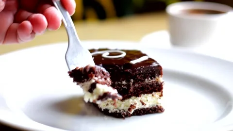Taking bite of chocolate cake with chocolate icing and buttercream Stock Footage 218319292