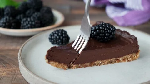 Taking bite of chocolate pie tart with a fork 스톡 동영상 137447566
