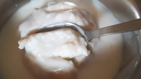 Taking Bite of Dahi Vada with Spoon Close-Up Video stock 333782412
