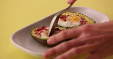 Taking a bite out of the avocado, eggs, and bacon 2 Stock Footage 132149614