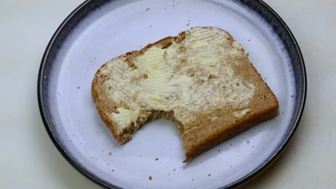 Taking a bite out of wheat bread toast Stock Footage 142713724