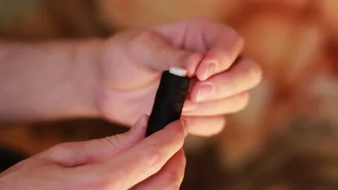 Taking black thread from a bobbin Stock Footage 73506166