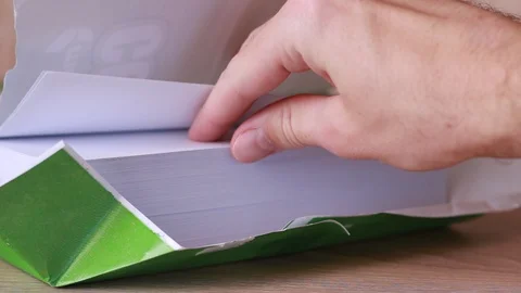 Taking blank sheet from pack Stock Footage 86231469
