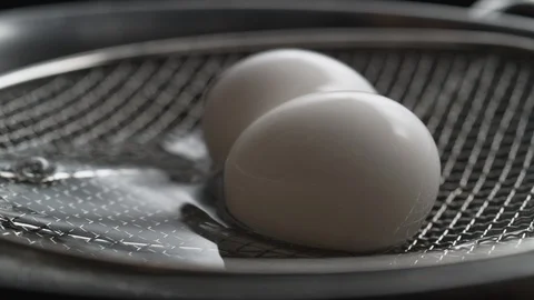 Taking boiled eggs out of boiled water. Slow Motion. Video stock 89813689