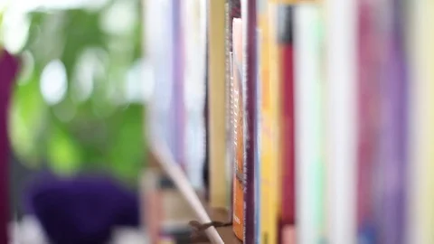 Taking a book out of shelf Stock Footage 82076799