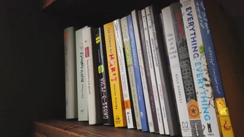 Taking books off the shelf Video stock 132630698