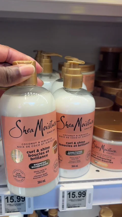 Taking a bottle of Shea Moisture shampoo from a store shelf Stock Footage 334580428