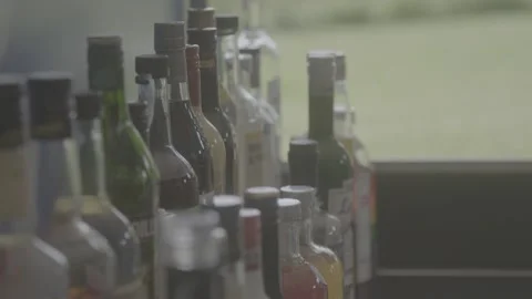 Taking from the bottle shelves Stock Footage 163442424
