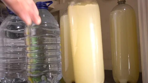 Taking bottles of soft drink from a cupboard. Stock Footage 91620899