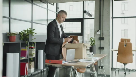 Taking box with personal stuff from office. Man by dismissal. Guy lost job Stock Footage 346590934