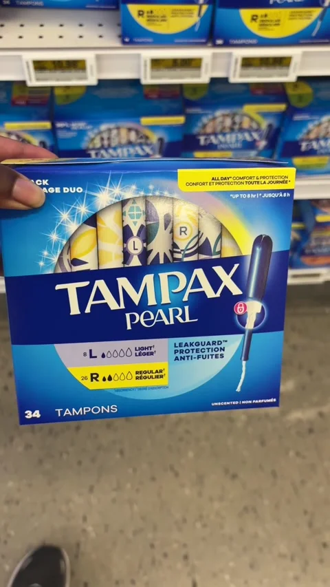 Taking a box of Tampax Pearl regular and light tampons from a store shelf 스톡 동영상 334580492