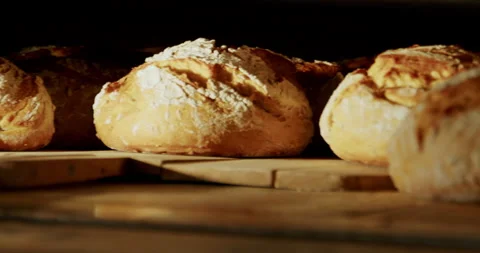 Taking bread out of the oven 4K. Stock Footage 221566576