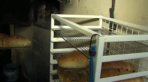 Taking bread out oven Stock Footage 18173314