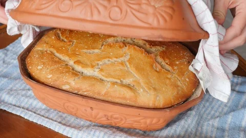 Taking bread from roman clay pot, vessel with water Stock Footage 87219754