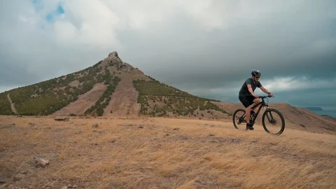 Taking a break during a bicycle ride in rural area next to mountains Stock Footage 114495498