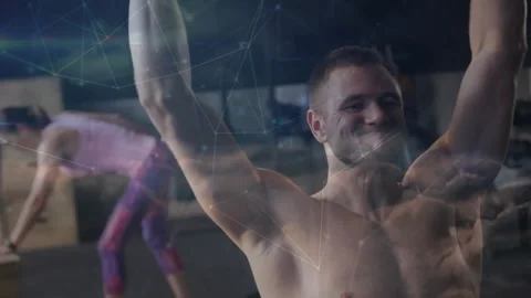 Taking breath shirtless man pressing hex dumbbells overhead at gym, woman in Stock Footage 331108549