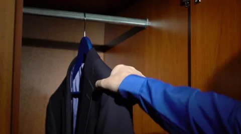 Taking a business jacket from a wardrobe Stock Footage 60057711