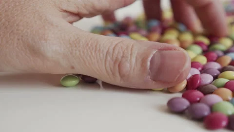 Taking button-shaped candies from table 4K slow-mo video Video stock 152541133