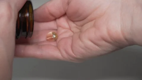 Taking a capsule from the jar Stock Footage 101587894