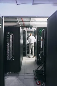 Taking care of data infrastructure. Rearview shot of a mature man using a laptop 写真素材
