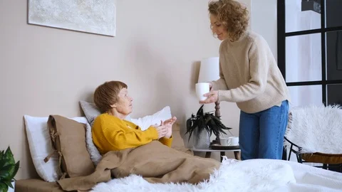 Taking Care of Elderly Parents and Seniors. Young Woman With Old Mother At Home. Stock Footage 104587322