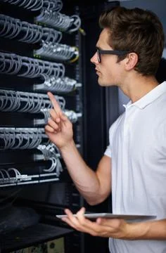 Taking care of your network needs. A computer technician fixing a server. Foto stock