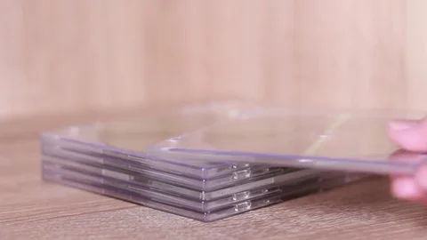 Taking CD from the pile Stock Footage 82196228