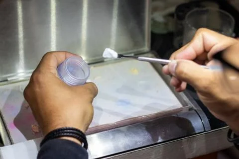 Taking the ceramic out of the container in order to create a new prosthetic t Stock Photos