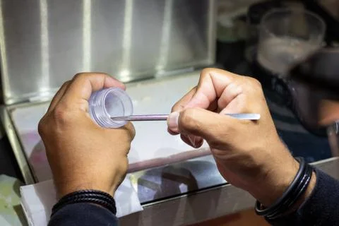 Taking the ceramic out of the container in order to create a new prosthetic t Stock Photos