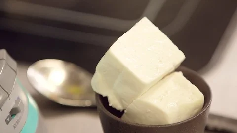 Taking cheese from bowl Stock Footage 77048954