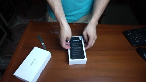 Taking a Chinese Umidig Bison cell phone out of its box Video stock 147470070
