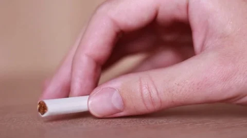 Taking the cigarette by tremored hand 動画素材 81857229
