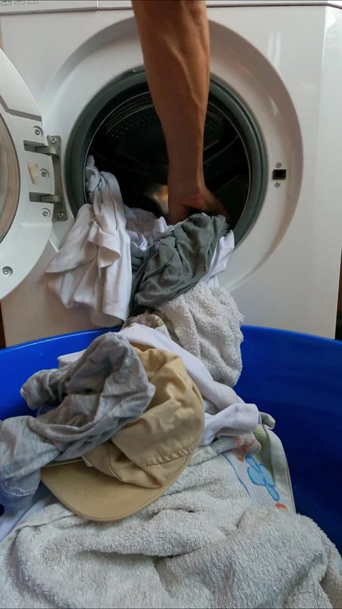 Taking clothes out of the washing machine Stock Footage 252283494