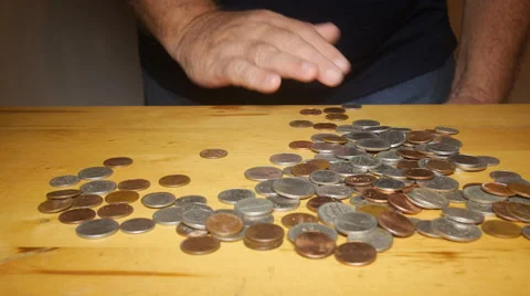 TAKING COINS FROM TABLE Stock Footage 54055414