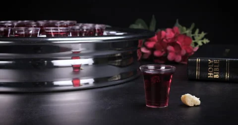 Taking communion the wine and the bread symbols on black background Stock Footage 234739603