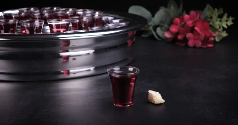 Taking communion the wine and the bread symbols on black background 스톡 동영상 234739710