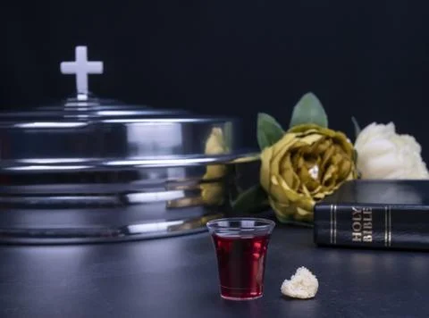 Taking communion the wine and the bread symbols on black background 스톡 사진