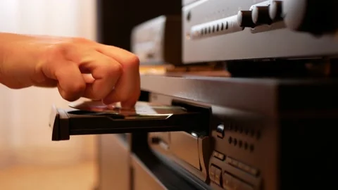 Taking of compact disc from the CD player and putting it in the plastic case Stock Footage 151720917