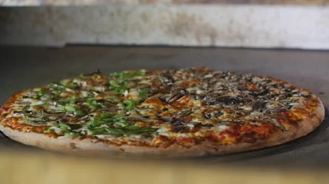 Taking Cooked Pizza Out Of Hot Commercial Industrial Stone Oven Restaurant Slow Vídeo Stock 66111618