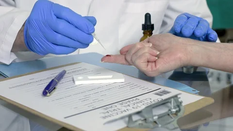 Taking coronavirus test sample from blood 4k Stock Footage 129773705