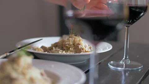 Taking the cup of red wine from the table Vídeo Stock 106935003
