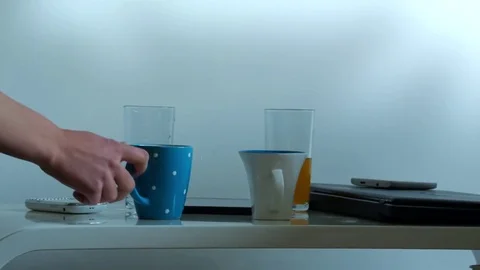 Taking Cup from Table Stock Footage 71354365