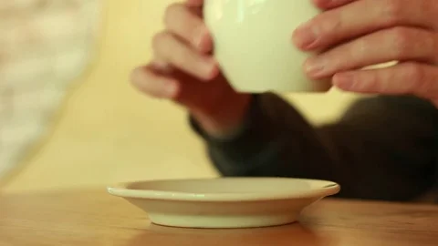 Taking a cup of tea with both hands and putting it back 動画素材 73506873