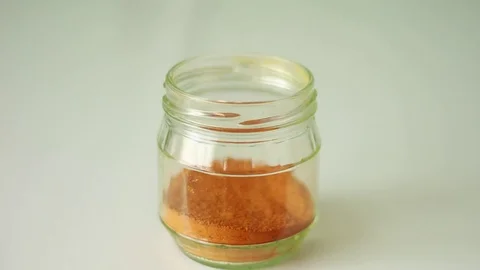 Taking curcuma from a glass can Видео 76996003