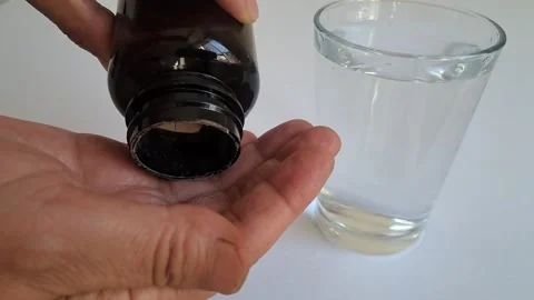 Taking Daily Supplement With Water Stock Footage 344687879