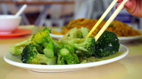 Taking delicious healthy nutritious broccoli and other vegetables with Stock Footage 182516763