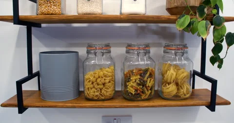 Taking a digestive biscuit out of a biscuit barrel then putting back in the Stock Footage 303575446