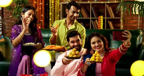 Taking Diwali selfie with sweets in decorated home in traditional festival Video stock 342382620